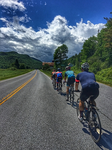 Line of riders approaching old barn